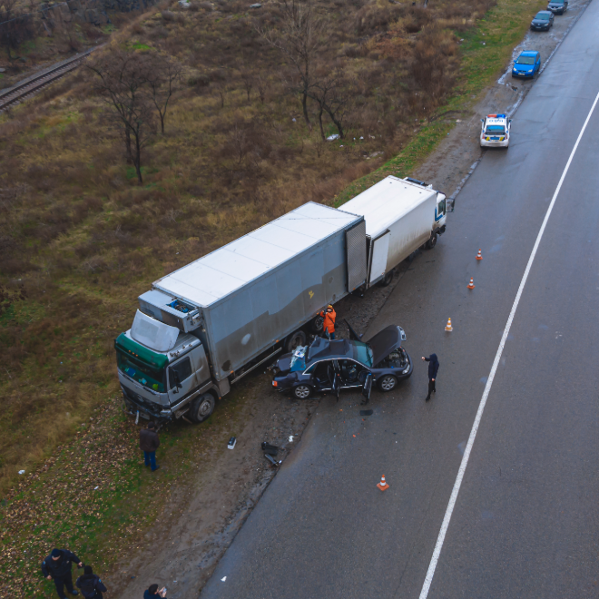 Aerial view of a box truck and car highway crash