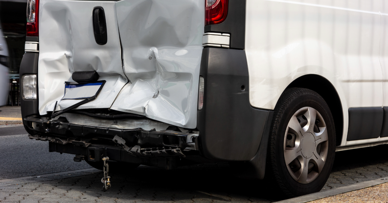 White cargo van side-impact damage