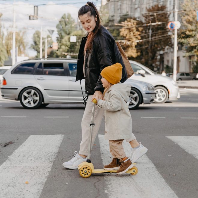 Parent and child crossing a painted crosswalk