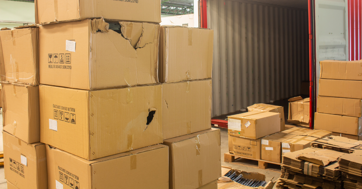 Stacked damaged delivery boxes inside a truck