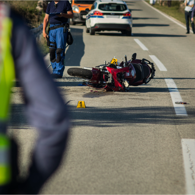 Motorcycle crash scene with road evidence markers
