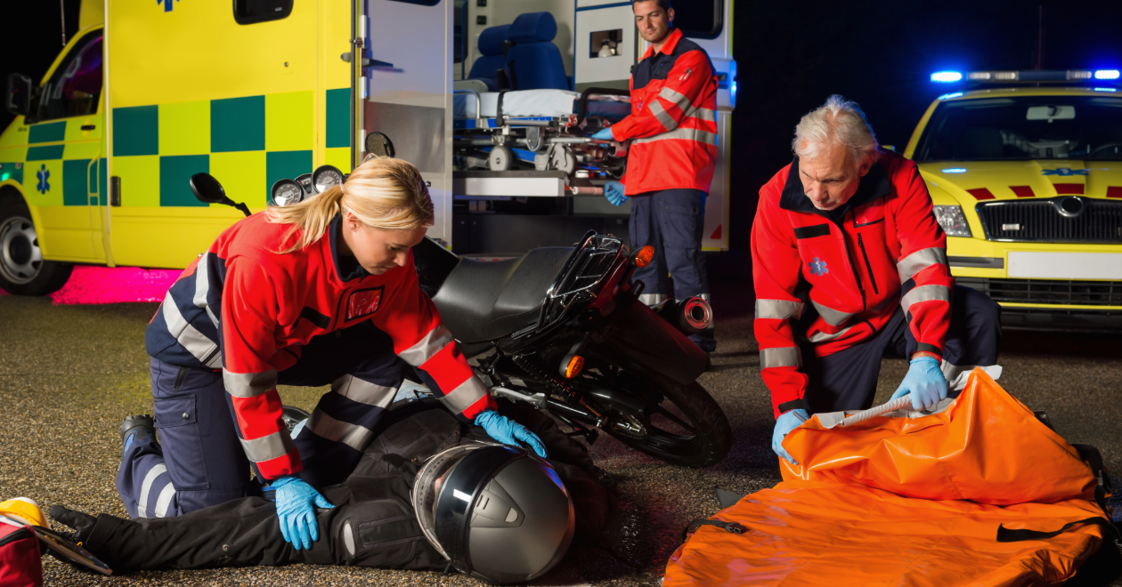 Paramedics treating an injured motorcyclist