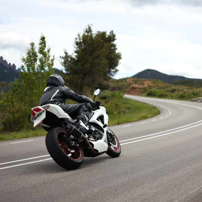 Sport motorcyclist riding a curved road