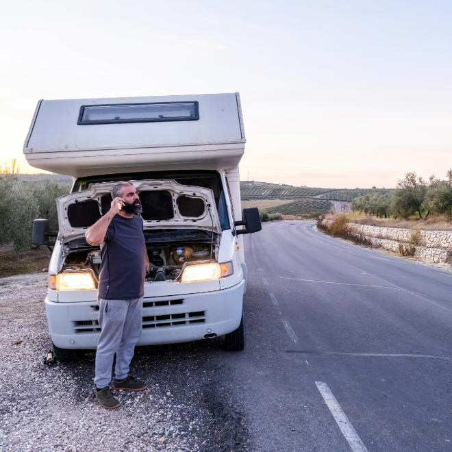 Camper van roadside breakdown with open rear hatch