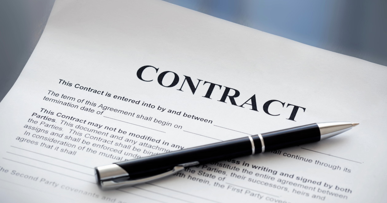 Legal contract document with a pen
