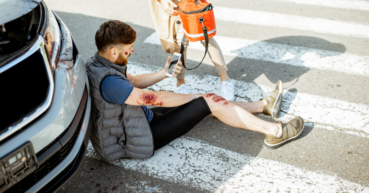 Injured pedestrian receiving emergency care in a crosswalk