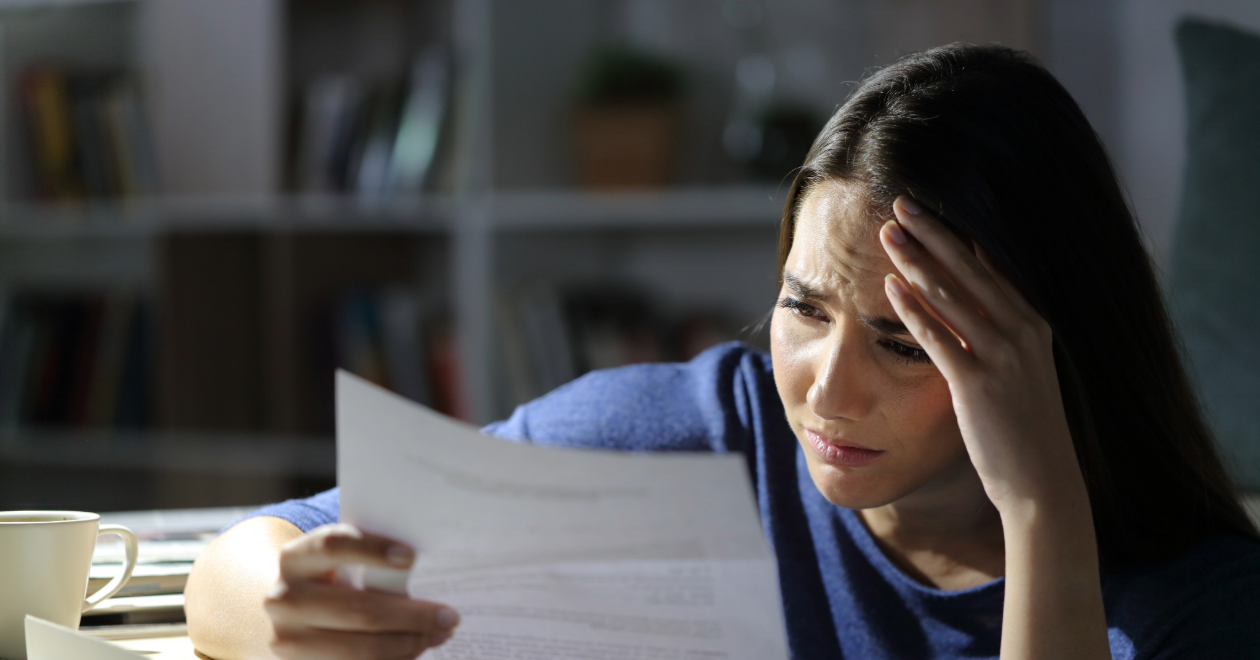Stressed woman reading an uninsured motorist insurance letter